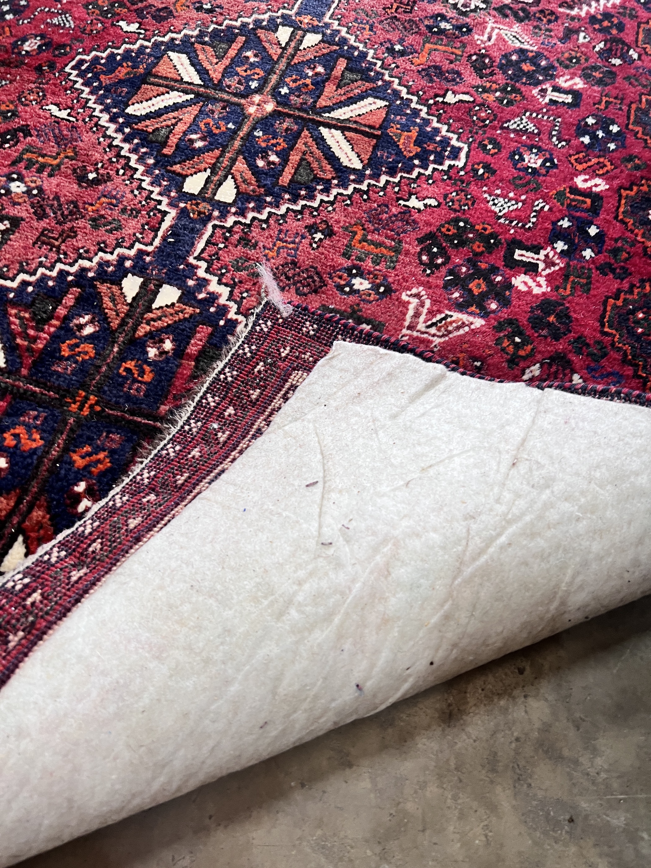 A Belouch red ground rug, 172 x 122cm